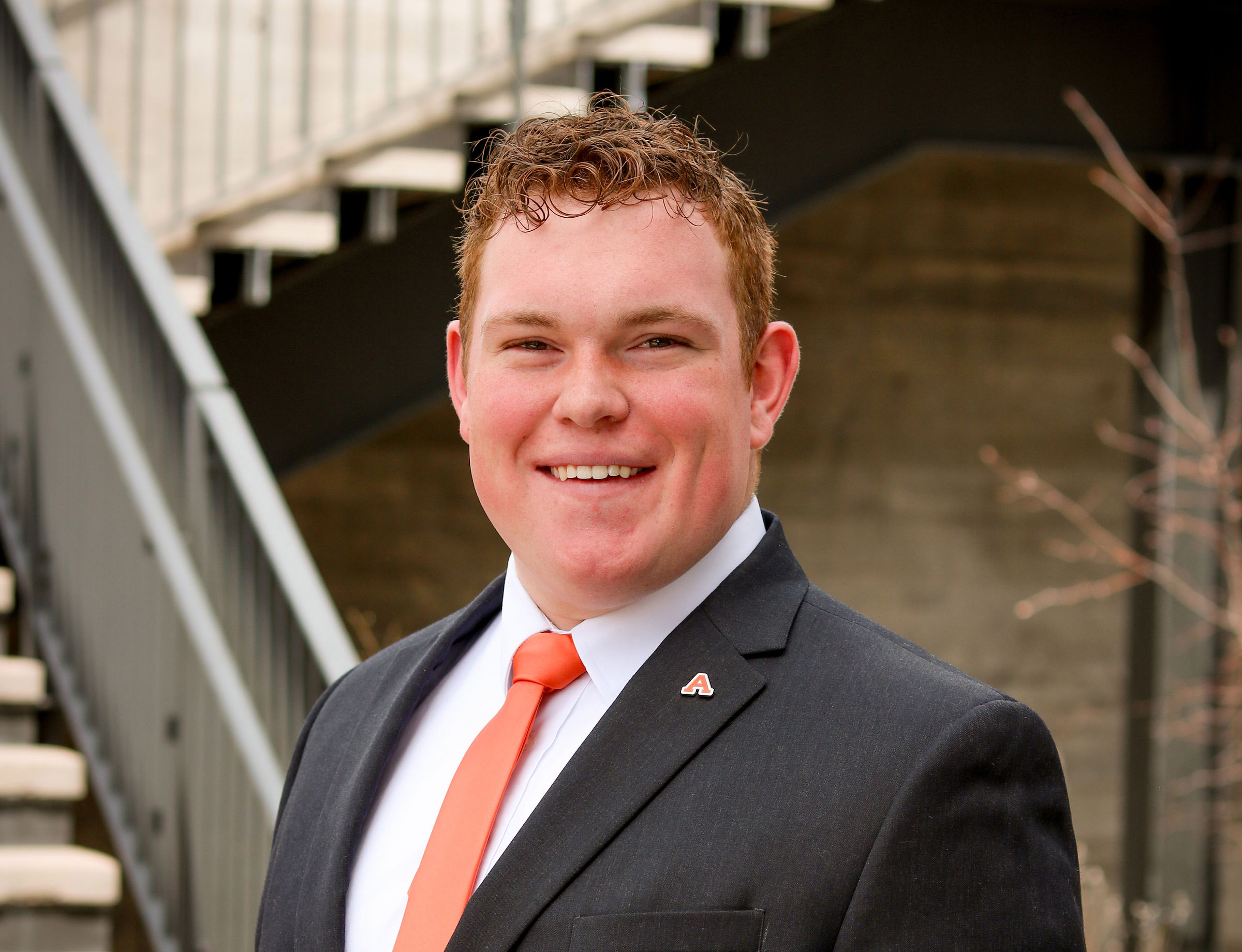 A headshot photo of Ryer Roberts against an outdoor background.