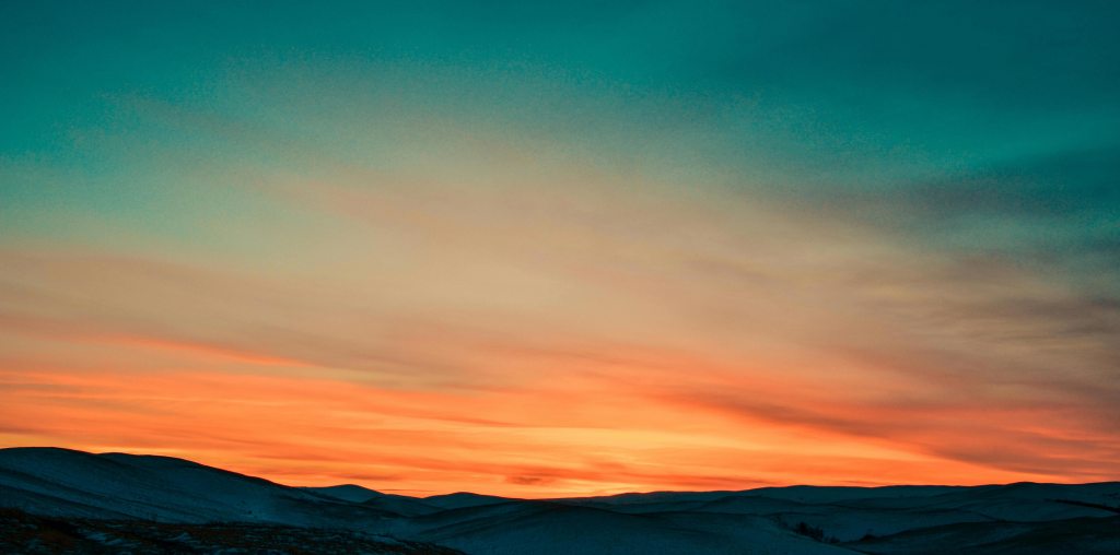 A blue and orange sunset over the mountains
