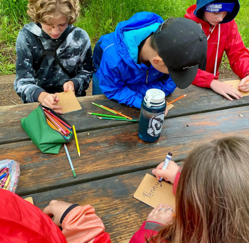 Youth participants in the Eco-Explorers Program work together at a table