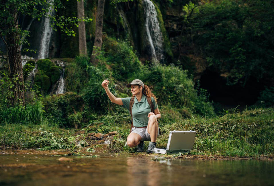 A person in a creek observing a vile.