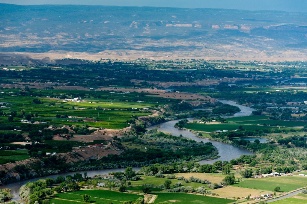 An aerial view of the Colorado River and Orchard Mesa from above Palisade, Colorado.