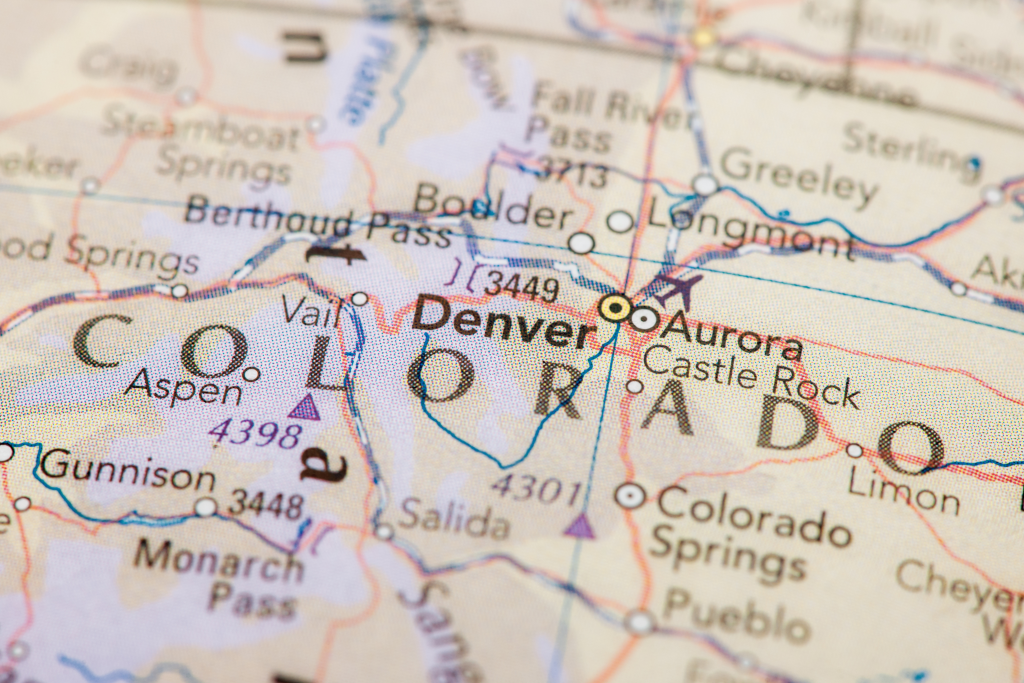 A close-up of a map of Colorado highlighting major cities and landmarks like Denver, Aspen, Boulder, Colorado Springs, and Vail.