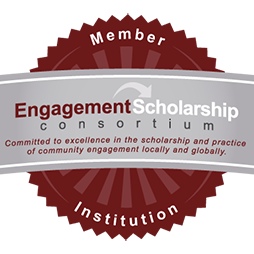 Maroon and gray badge representing the Engagement Scholarship Consortium member institution, with a ribbon that emphasizes commitment to community engagement.