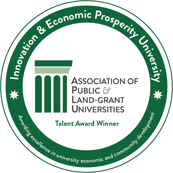 A green circular seal awarded by the Association of Public and Land-grant Universities (APLU) for innovation, economic prosperity, and community development, with a column icon in the center.