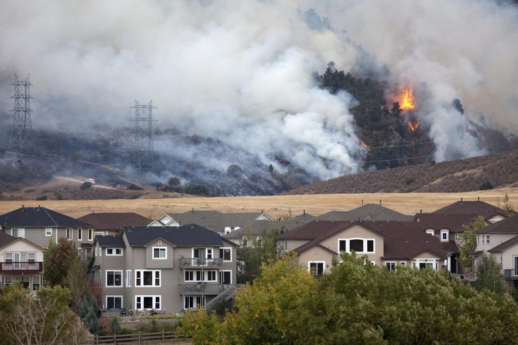 A wildfire causes smoke near a residential neighborhood